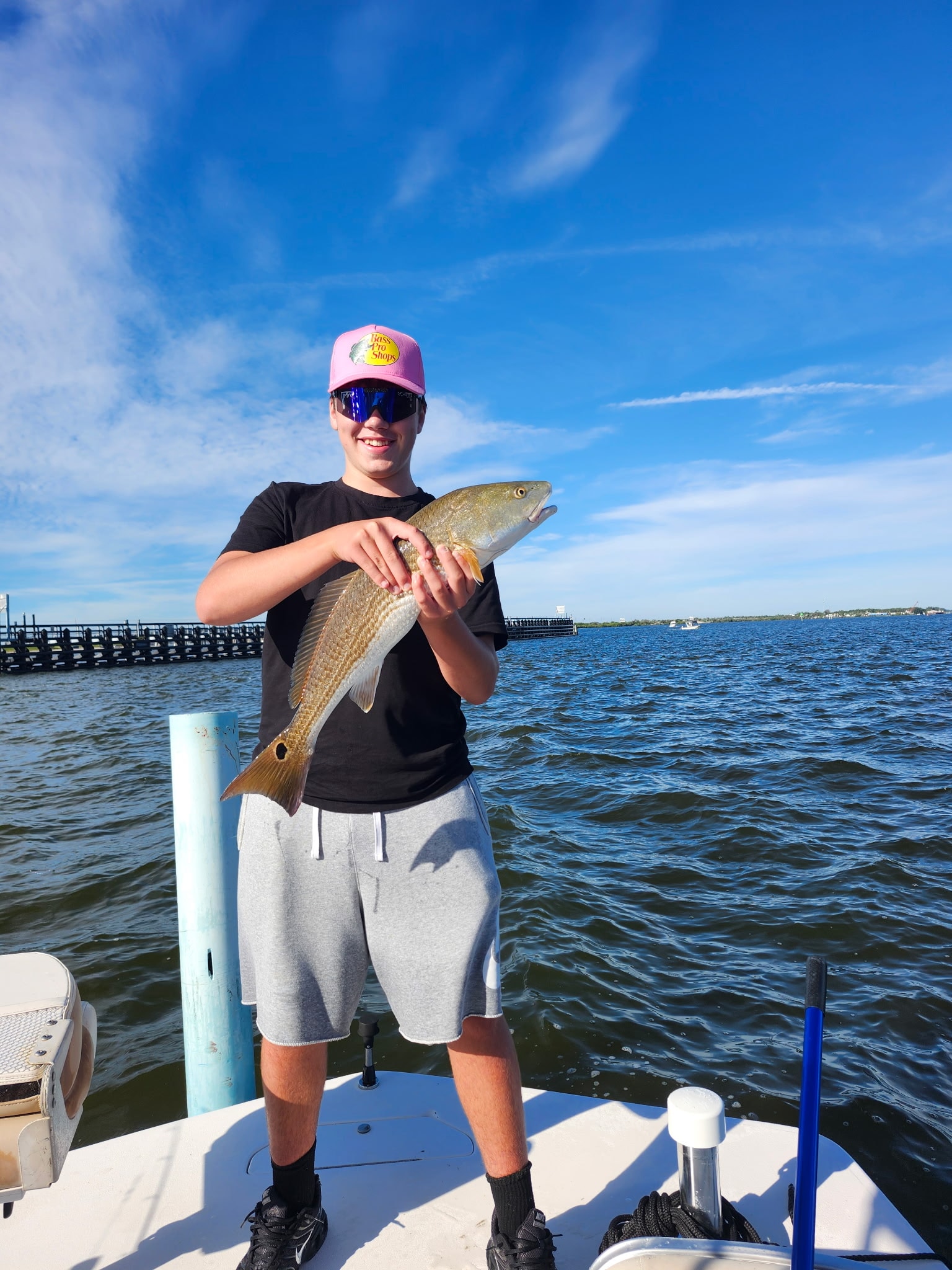 Young angler holding a red drum caught on the Indian River Lagoon